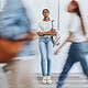 Overwhelmed young woman standing in busy crowd at mental health awareness event.