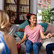 Supportive therapy session with diverse young women in a cozy living room.